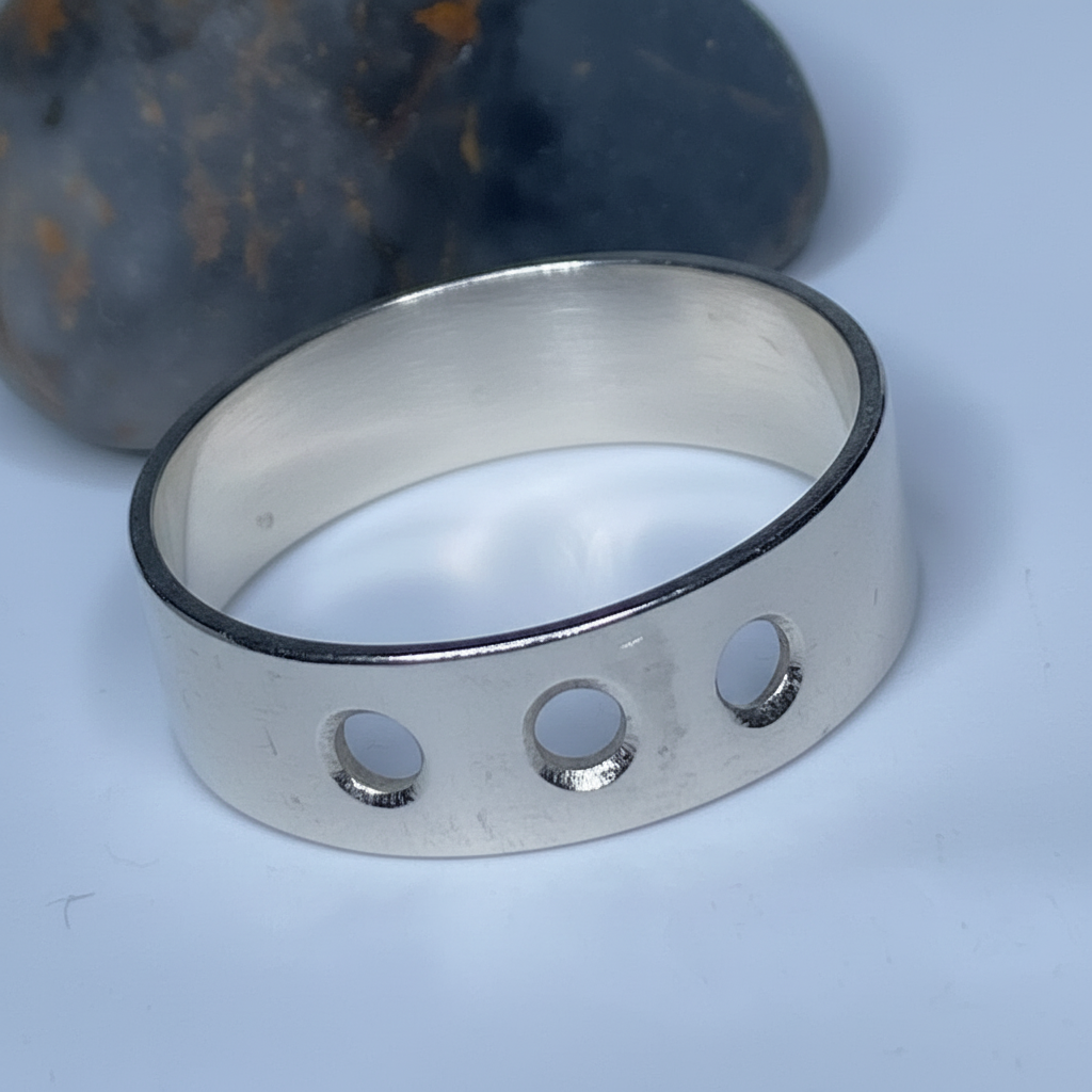 Silver ring with 3 cut circles